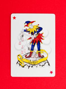 Playing card (joker) isolated on a red background