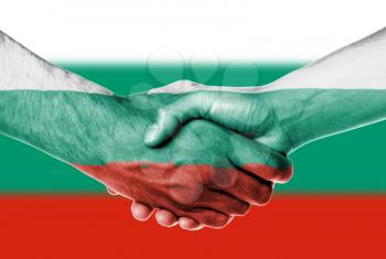Man and woman shaking hands, wrapped in flag pattern, Bulgaria