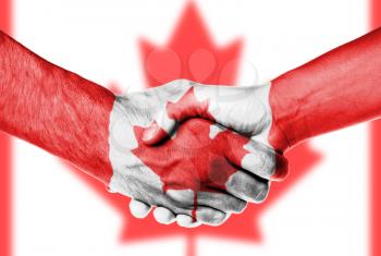 Man and woman shaking hands, wrapped in flag pattern, Canada