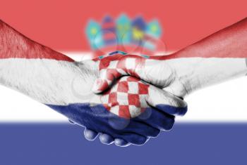 Man and woman shaking hands, wrapped in flag pattern, Croatia