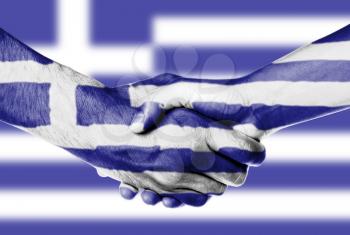 Man and woman shaking hands, wrapped in flag pattern, Greece