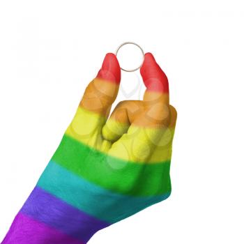 Man holding a silver ring, rainbow flag pattern