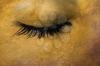 Women eye, close-up, concept of sadness, gold