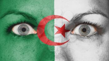 Close up of eyes. Painted face with flag of Algeria