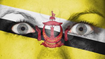 Close up of eyes. Painted face with flag of Brunei