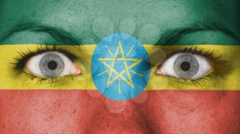 Close up of eyes. Painted face with flag of Ethiopia