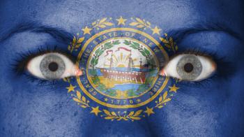 Close up of eyes. Painted face with flag of New Hampshire