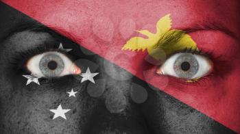 Close up of eyes. Painted face with flag of Papua New Guinea