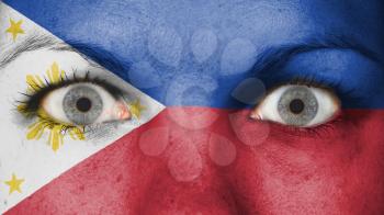 Close up of eyes. Painted face with flag of Philippines