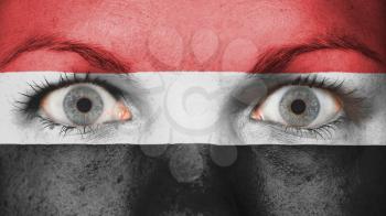 Close up of eyes. Painted face with flag of Yemen