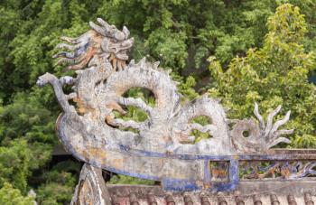 Chinese dragon ornament on a rooftop in the Vietnamese jungle