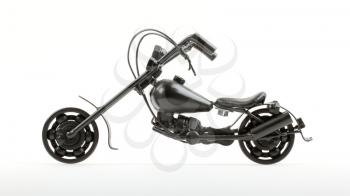 Mini motorcycle made from wire and different motorcycle parts, on white background
