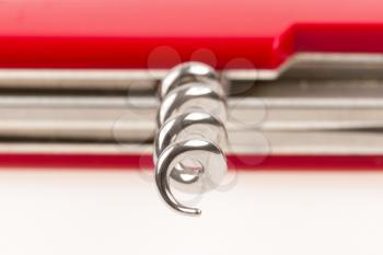 Red swiss army knife isolated, focus on the point of the corkscrew