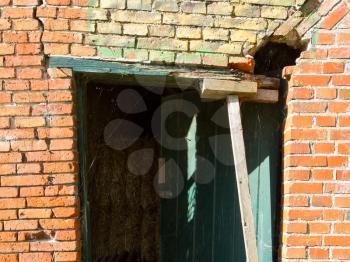 Broken doorway in an old brick wall
