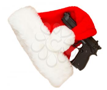 Weapon (firearm) concealed in santas hat, isolated on white