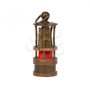 Very old miniature of a miners lamp, isolated on white