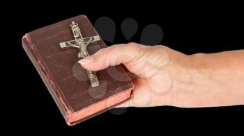 Old hand (woman) holding a very old bible, isolated on white