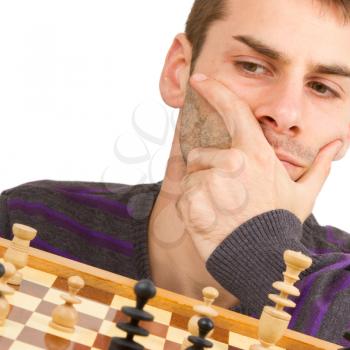 Chessboard with desperate man thinking about chess strategy, isolated on white