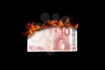 Burning money, euro bill on fire, isolated on black