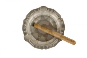 Unused large cigar in an old tin ashtray, isolated on white