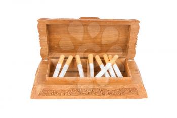 Cigarettes in handcarved wooden box, isolated on white