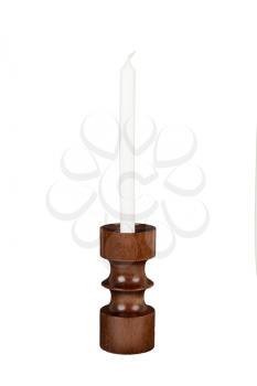 Old antique wooden candlestick candleholder with vintage candle isolated on white