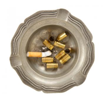 Empty 9mm bullet casings in an old tin ashtray, isolated