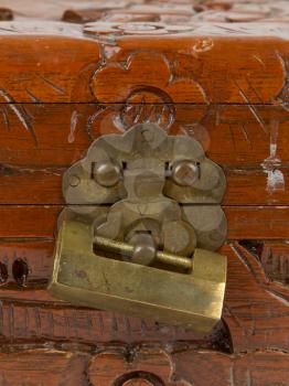 Old padlock on a wooden chest made in Suriname, isolated on white