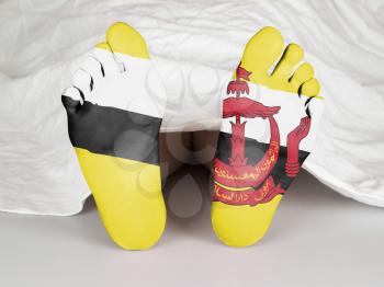 Feet with flag, sleeping or death concept, flag of Brunei