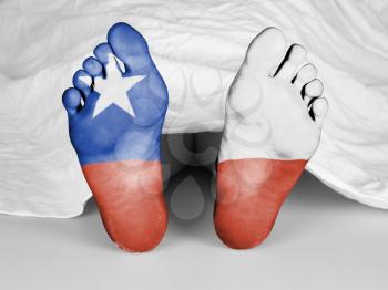 Dead body under a white sheet, flag of Chile