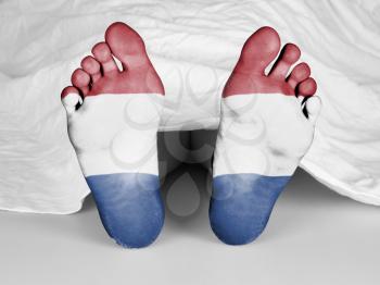 Dead body under a white sheet, flag of Holland