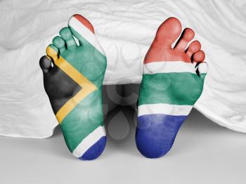 Dead body under a white sheet, flag of South Africa