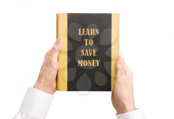 Businessman holding an old book, learn to save money
