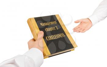 Businessman giving an used book to another businessman, management chapter 1 - indifference