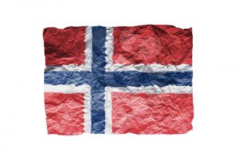 Close up of a curled paper on white background, print of the flag of Norway