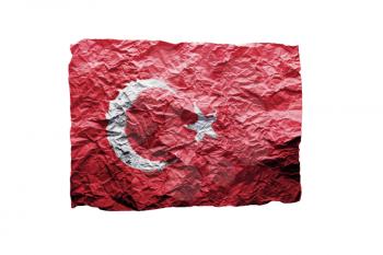 Close up of a curled paper on white background, print of the flag of Turkey