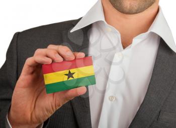 Businessman is holding a business card, flag of Ghana
