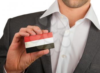 Businessman is holding a business card, flag of Yemen