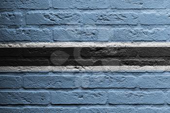 Brick wall with a painting of a flag isolated, Botswana
