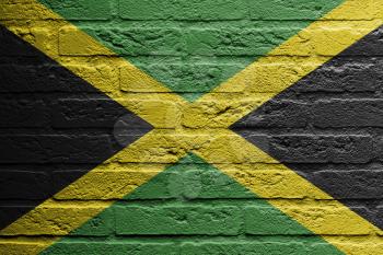 Brick wall with a painting of a flag isolated, Jamaica
