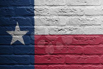 Brick wall with a painting of a flag isolated, Texas