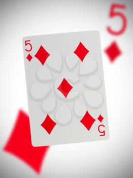 Playing card with a blurry background, five