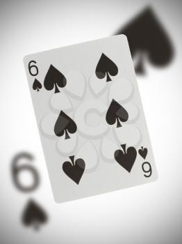 Playing card with a blurry background, six of spades