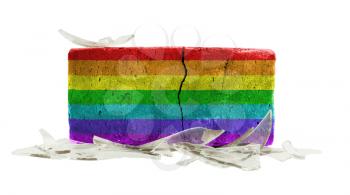 Brick with broken glass, violence concept, rainbow flag