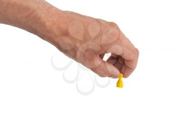 Hand holding a yellow pawn, isolated on white