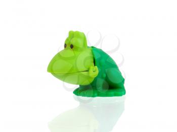 Old green plastic toy frog on white background