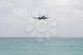 ST MARTIN, ANTILLES - JULY 19, 2013: JetBlue is the fastest growing airline in the world. Embraer JetBlue lands on Juliana International Airport in Netherlands Antilles in July 19, 2013 in St Martin.