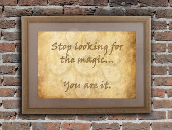 Old wooden frame with written text on an old wall - Stop looking for the magic