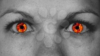 Detail view of female eyes with flames instead of the iris