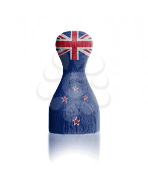 Wooden pawn with a painting of a flag, New Zealand